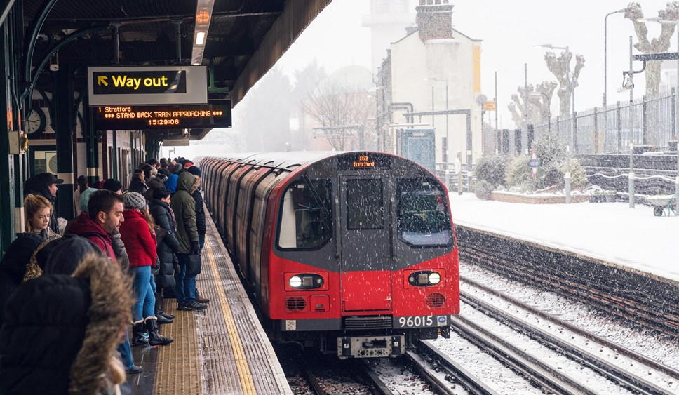 London Underground train pulling into station in the snow