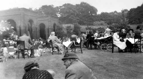 Lotherton walled garden party - Leodis: Image from late 1940s/early 1950s, showing people seated at tables enjoying a summer garden party in the walled garden of Lotherton Hall. 
Credit: Leodis.net