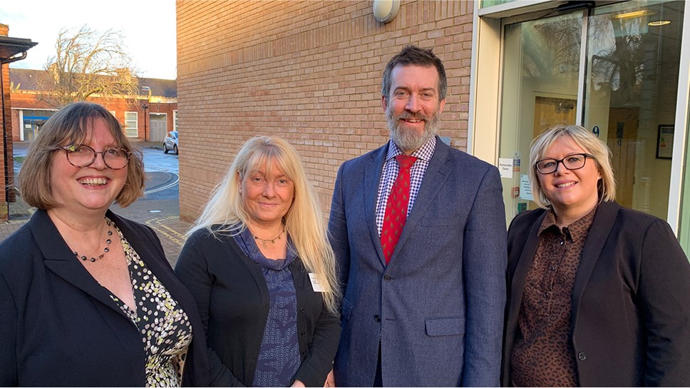 Two female University of Cumbria Institute of Education academics with two senior education figures at Cumbria County Council.