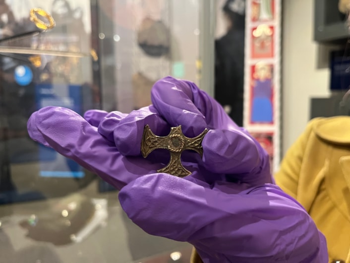 Saxon cross display: Believed to have once been a prestigious badge of office and a sign of religious identity, the silver, gilded pendant was discovered by a metal detectorist, with one of its four arms broken, and its central stone missing.
Newly created drawings, penned by archaeological illustrator John Prudhoe, show how the complete cross could have looked with its thin layer of gold leaf shining and a beautiful central garnet.