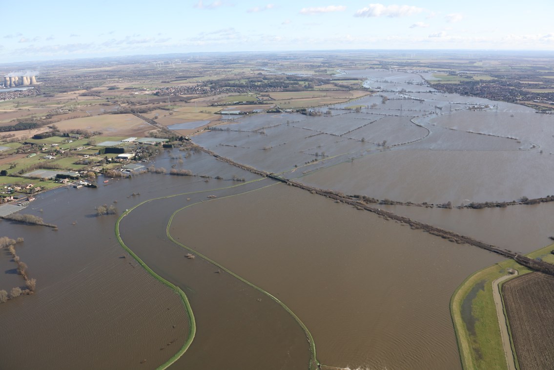 Network Rail joins industry experts for pilot programme aimed at keeping passengers moving in adverse weather: photo showing extent of flooding of railway line near Drax power plant