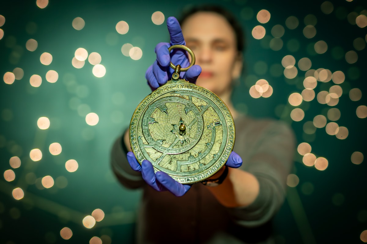 Dr Rebekah Higgitt of National Museums Scotland examines an 11th century astronomical instrument known as an astrolabe on the 1000th anniversary of its manufacture. The astrolabe, which was used to observe, calculate and predict the position of the Sun and the stars, is on display at the National Museum of Scotland in Edinburgh. Image © Andy Catlin   003