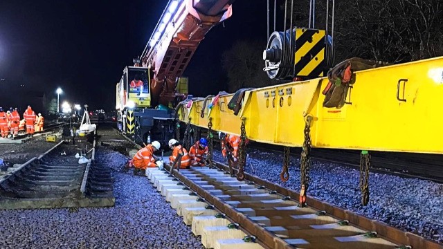 Library image of Network Rail engineers positioning section of railway track landscape: Library image of Network Rail engineers positioning section of railway track landscape