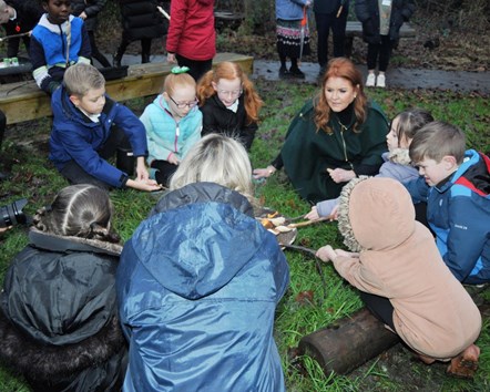 The Duchess of York with youngsters and staff at Padiham Green CofE Primary School's Forest School campfire