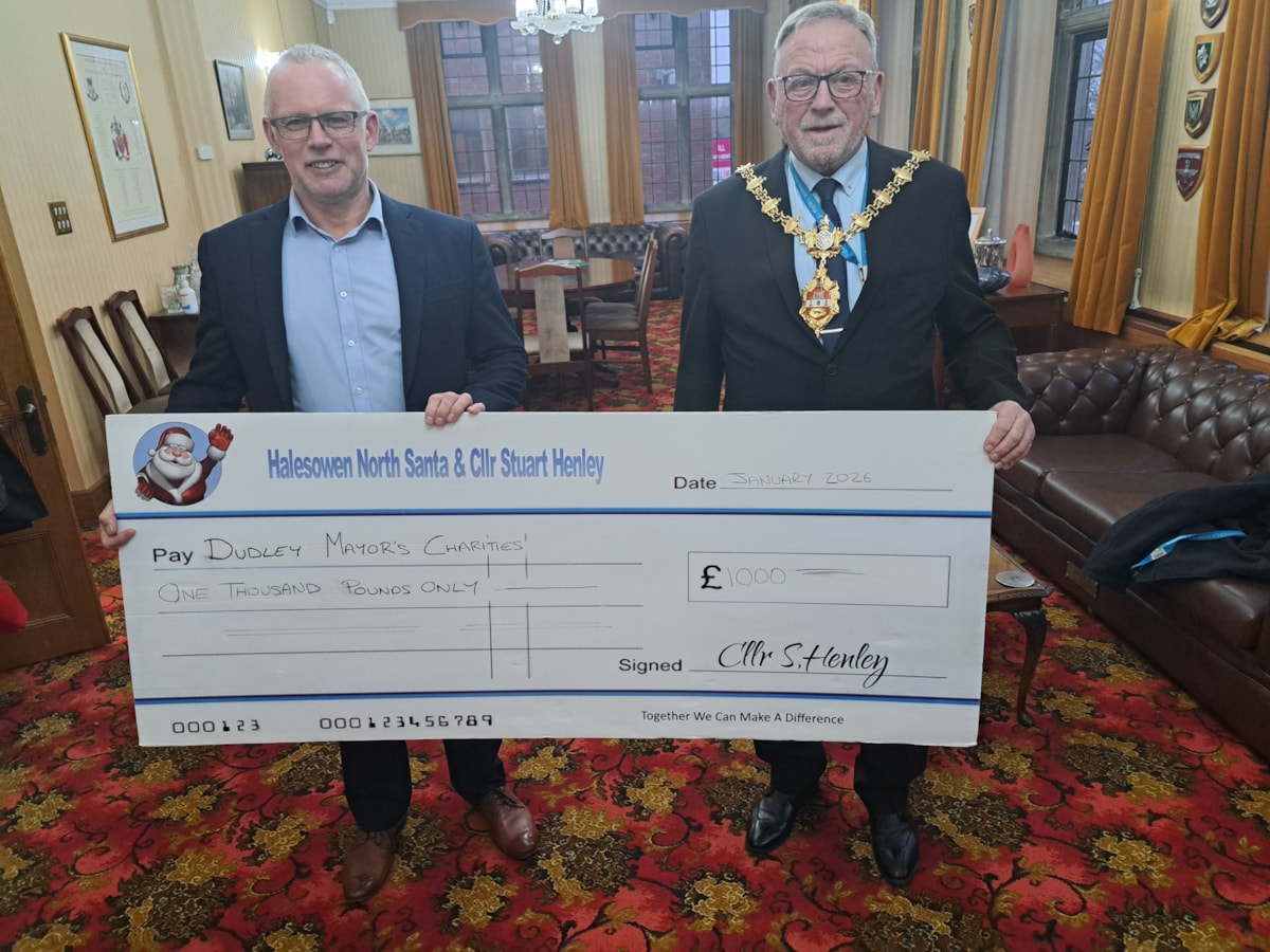 Cllr Stuart Henley presents the Mayor with a cheque for his charities