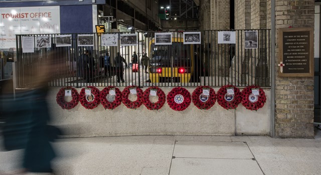 Commuters stream past wreaths laid in honour of the Unknown Warrior at Victoria Station