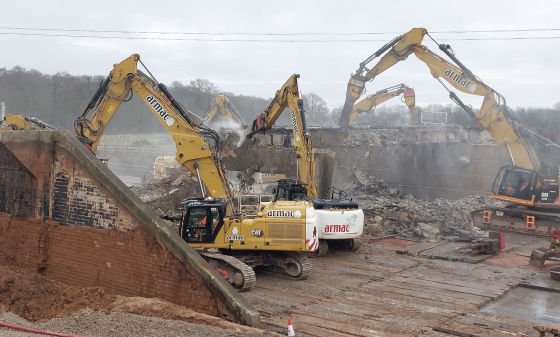 Excavators demolishing the bridge over the M42