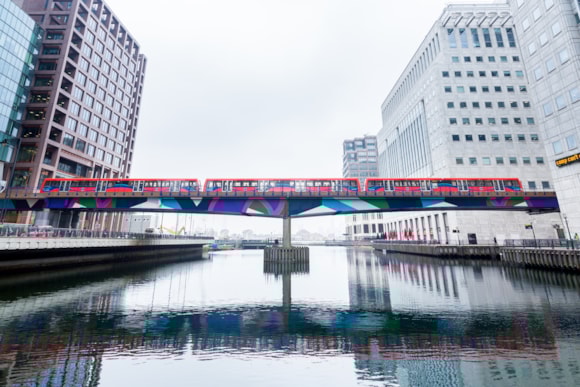 Have your say on the latest plans to extend the DLR to Beckton Riverside and Thamesmead: TfL Image - A DLR train crosses Middle Dock in Canary Wharf