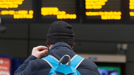 Image shows customer at departure screens
