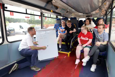 Teacher James Paylor explains travel safety with students
