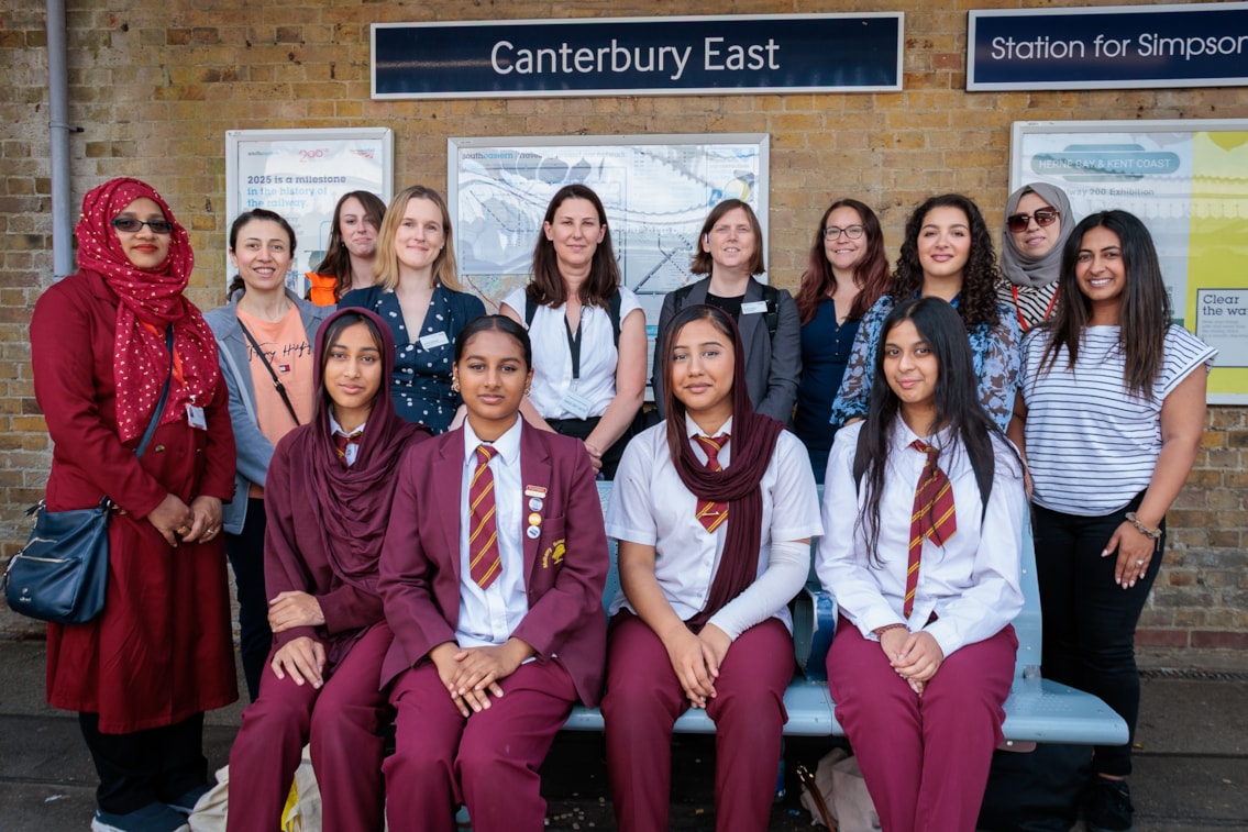 Group of rail engineers and schoolgirls at Canterbury East station
