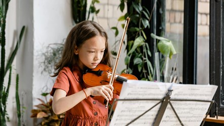 young girl  playing a violin credit pexels-mart-production-8471931