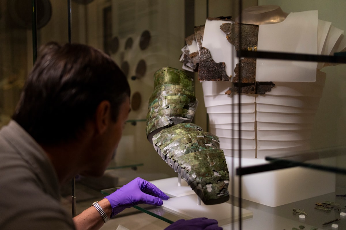 Dr Fraser Hunter installs the Roman arm guard in the Early People gallery at the National Museum of Scoltand. Image copyright Duncan McGlynn (6)