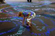 Child exploring 'The Words That Bind Us' Artwork in Durham Cathedral Nave