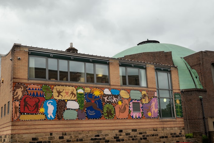 On the Pitch, Off the Pitch Murals: A vibrant mural depicting the city’s rich dance heritage adorns the Northern School of Contemporary Dance courtesy of artist by Herfa Thompson.