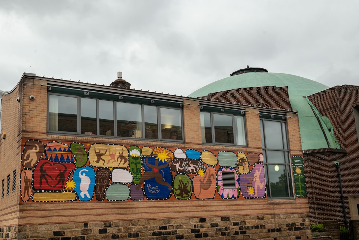 On the Pitch, Off the Pitch Murals: A vibrant mural depicting the city’s rich dance heritage adorns the Northern School of Contemporary Dance courtesy of artist by Herfa Thompson.