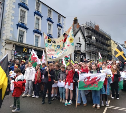 Schools marched down the high street with banners and flags