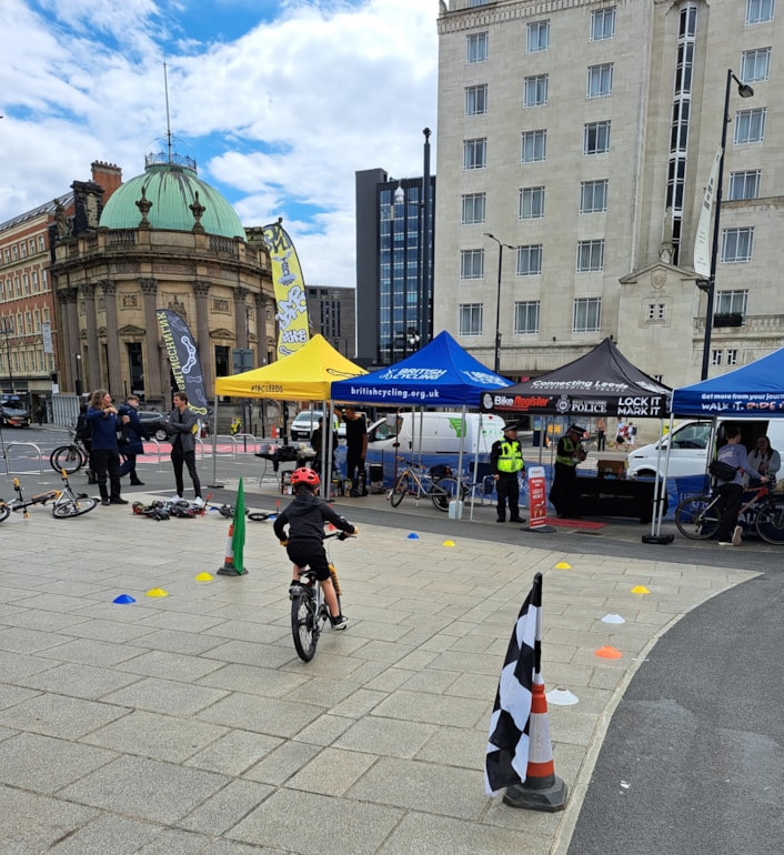 City Square cycling pump track: Image shows a boy wearing a red helmet cycling in City Square.