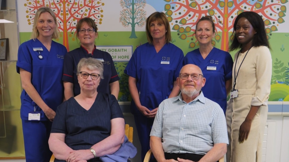 Patient Sharon Bettinson, from Caerphilly, with her husband and staff at Velindre Cancer Centre