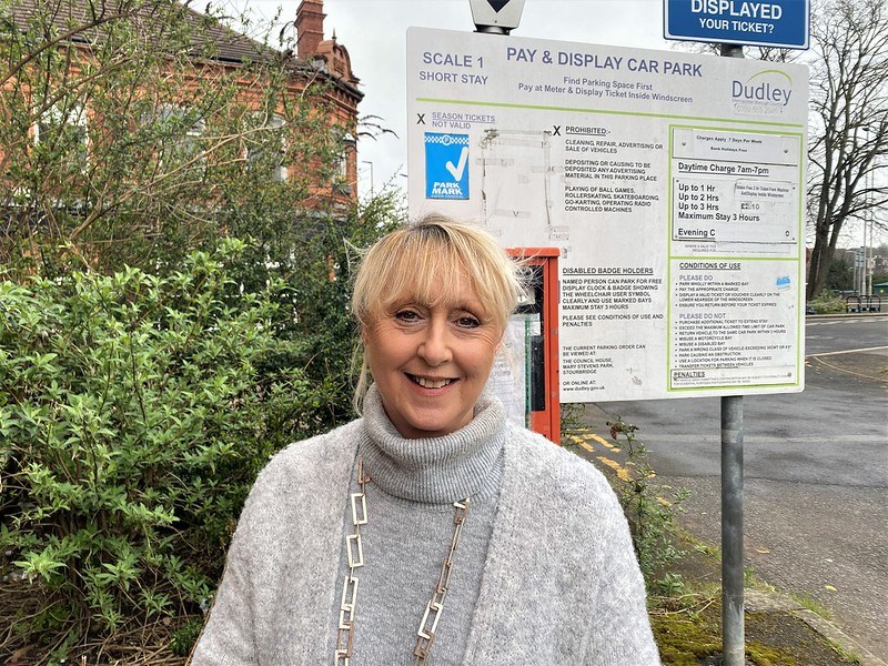 Karen next to parking pay machine