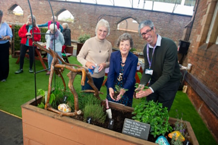 From left to right: Penrith Community Gardener, Joan Robinson; Mayor of Penrith, Councillor Val Bowen; and Damien Henderson, Senior Regional Growth Manager at Avanti West Coast, mark the opening of the herb-themed picnic garden at Penrith station.