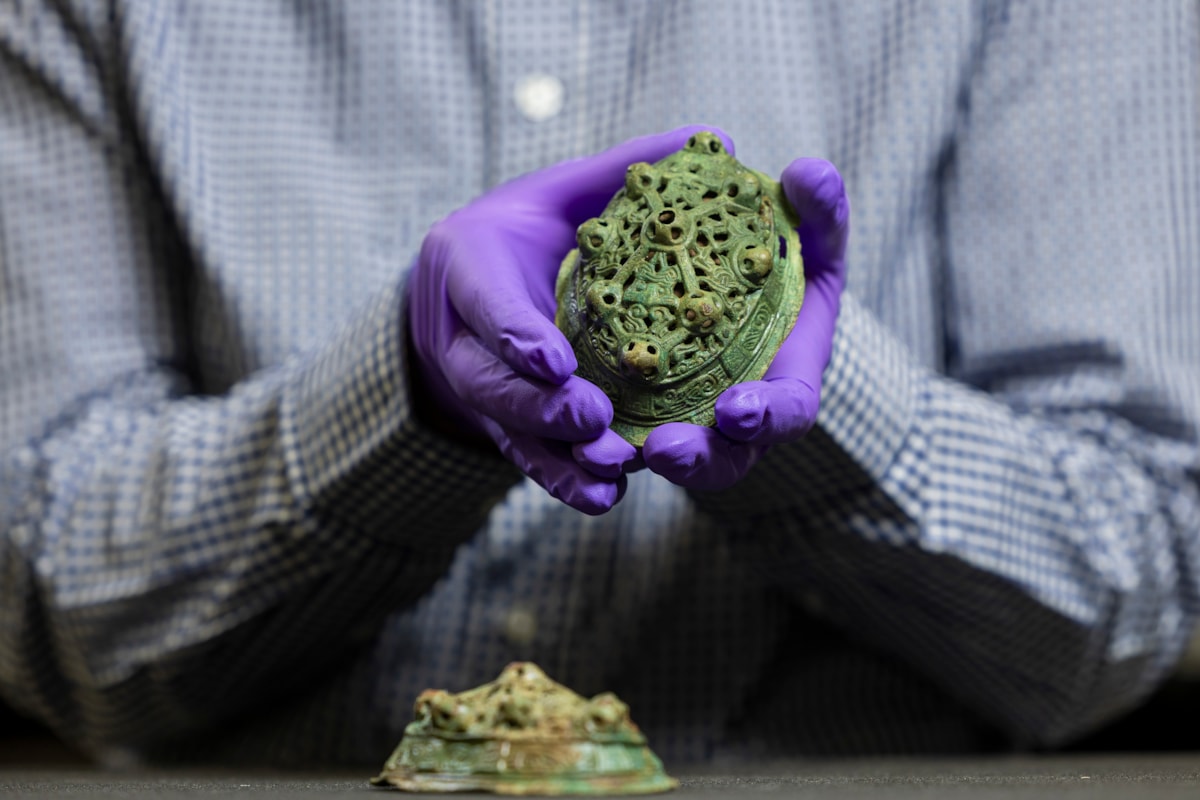 Assistant Curator Craig Angus with Viking brooches. Photo © Duncan McGlynn (1)
