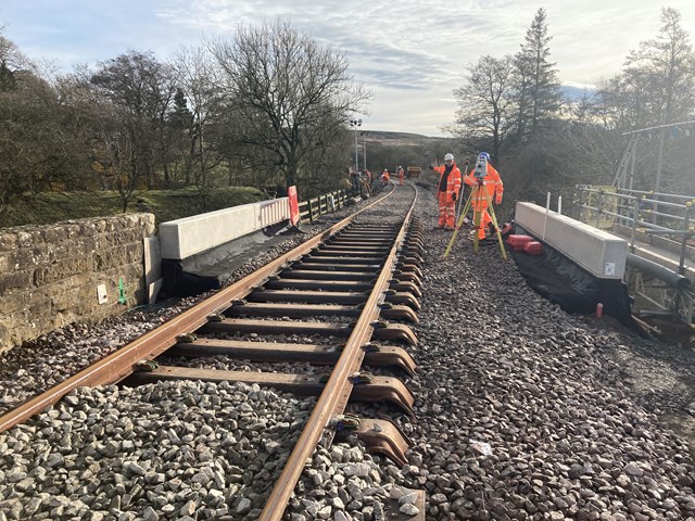 New track, sleepers and ballast laid over the top of the new bridge deck near Commondale station: New track, sleepers and ballast laid over the top of the new bridge deck near Commondale station