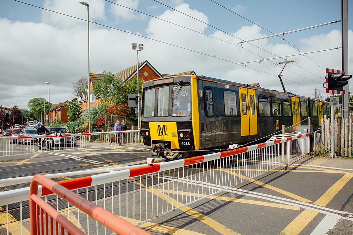 Metro train at level crossing - Image provided by Nexus