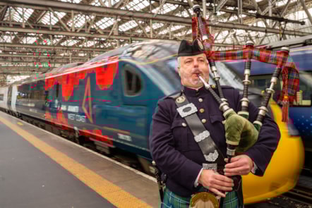A piper with the Poppy Train at Glasgow Central Station.