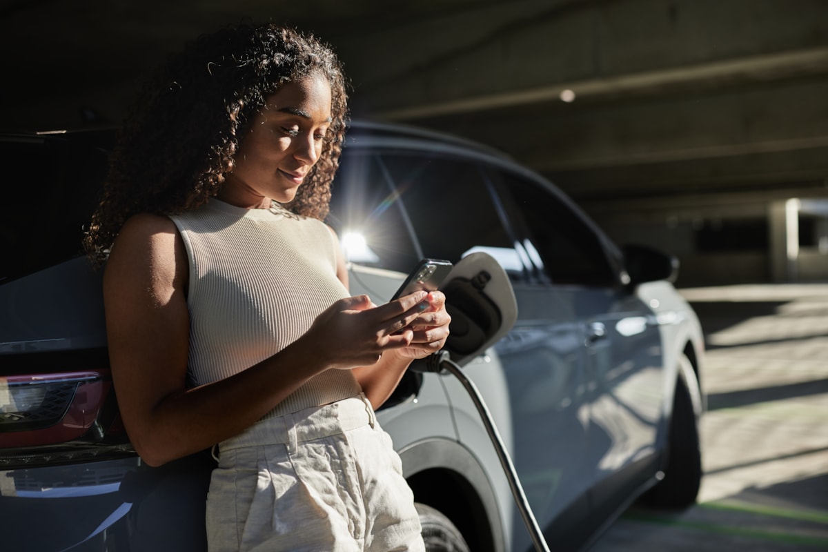 EV charging woman leaning