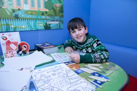 A child colours in the new LNER Family Lounge at Edinburgh Waverley