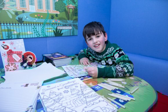 A child colours in the new LNER Family Lounge at Edinburgh Waverley