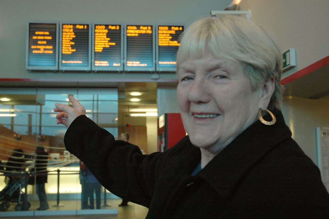 Stockport information screens: Councillor Marueen Rowles pointing to the newly installed information screens above the ticket office at Stockport station (11 December 2006).