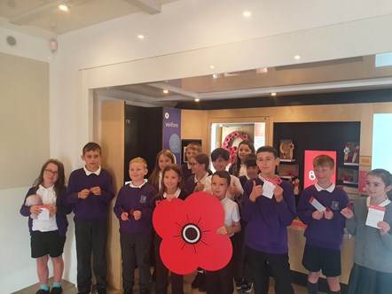 Pupils from four classes show the plastic paper-free poppies they made aboard Bud the Poppy bus, Popyyscotland's interactive mobile museum, which visited Seafield Primary School in Elgin.