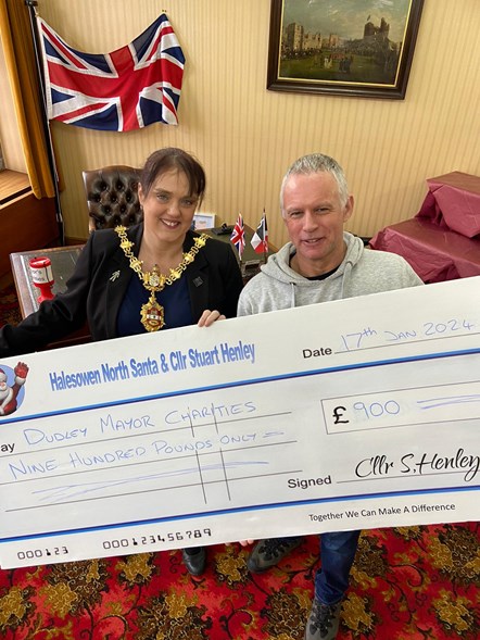 The Mayor of Dudley receives a donation for her charities from Cllr Stuart Henley and the Halesowen Santa Runs