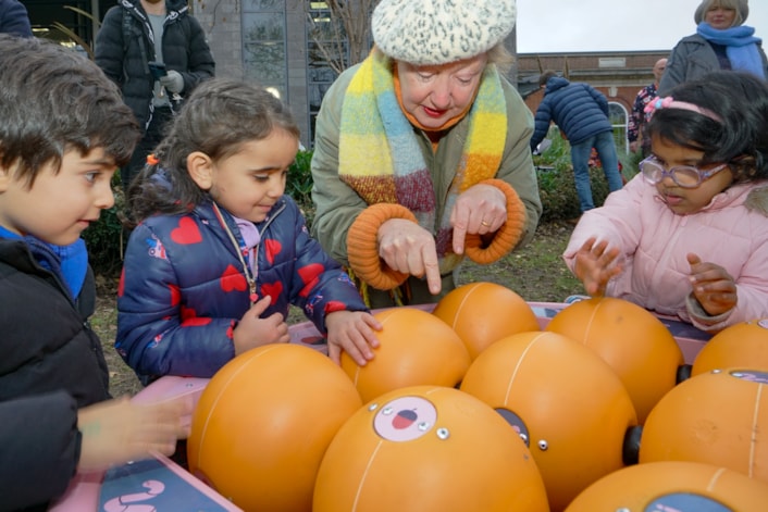 Compton 10: Children get to grips with one of the new installations, with help from artist Clare Devlin.