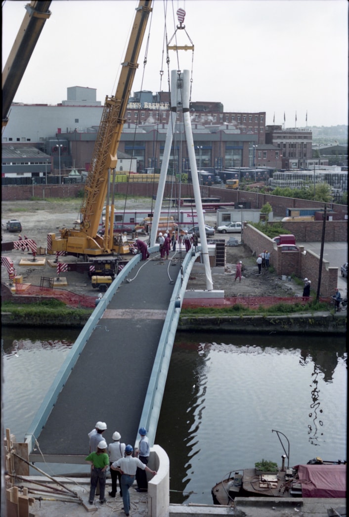 Centenary Bridge: Originally constructed in 1993, at that time the bridge was the first river crossing built in the city for more than a century, and its distinctive sweeping design has since become a much-loved riverside feature. Picture shows the bridge being winched into place during construction. Credit Yorkshire Design Group.