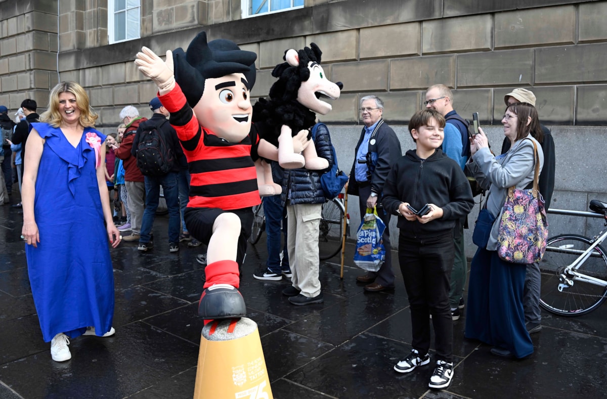 Beano fans queue outside the National Library of Scotland's George IV Bridge building. The Library was giving away special centenary editions of the comic to mark the Library's 100 birthday, which fell on 7 August. Credit: Neil Hanna