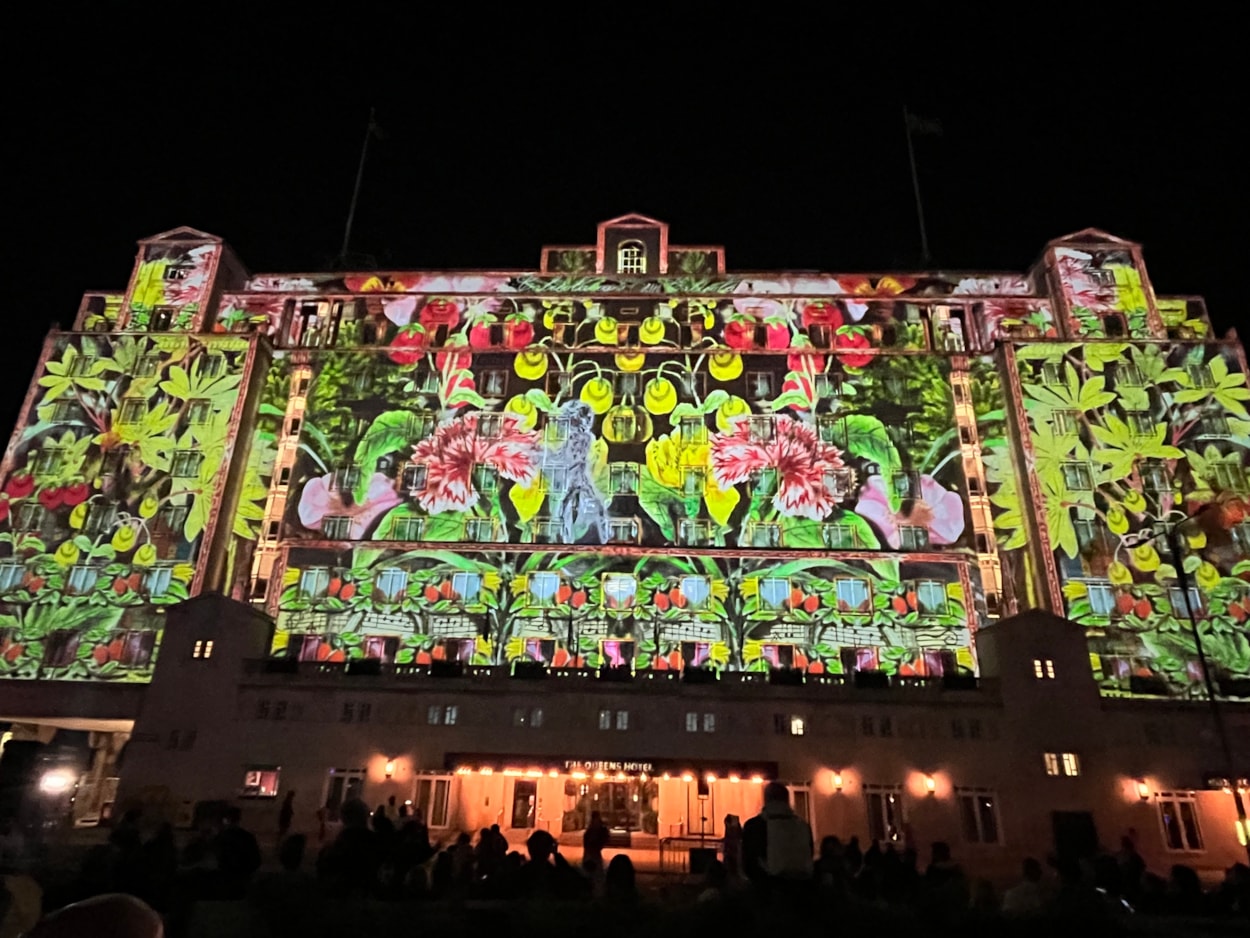 Light Night 2024: At The Queens Hotel The BookBinder saw a fairy tale figure lead a cast of birds, beasts and boats, in an impressive projection across the iconic hotel’s façade.
A collaboration with the British Library and created by artists Illuminos,  the piece is inspired by British Library’s Flickr Commons collection which includes fantastical drawings, prints and images.