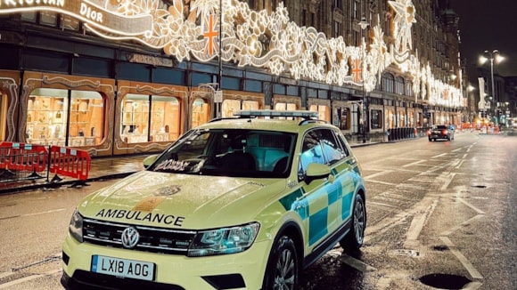 Sing to save lives at London Ambulance Service Christmas carol service: LAS vehicle and Christmas lights