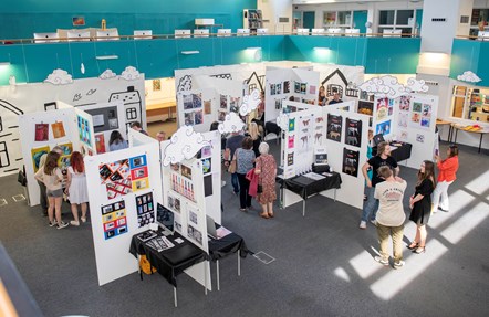 High view of visitors looking around part of the University of Cumbria Creative Community 2023 art exhibition