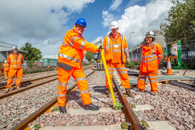 Aberdeen-Dyce rail enhancements on-track for successful completion: Aberdeen track 1 - Alex Hynes helping clip final section of rail into place