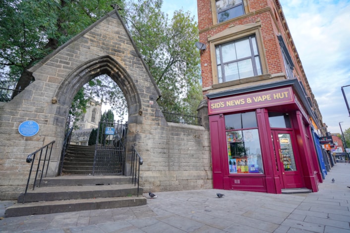 Heritage 4: A set of steps on New Briggate leading to St John's churchyard. Yorkstone paving has been put in place at the approach to the steps as part of heritage-led improvement work.