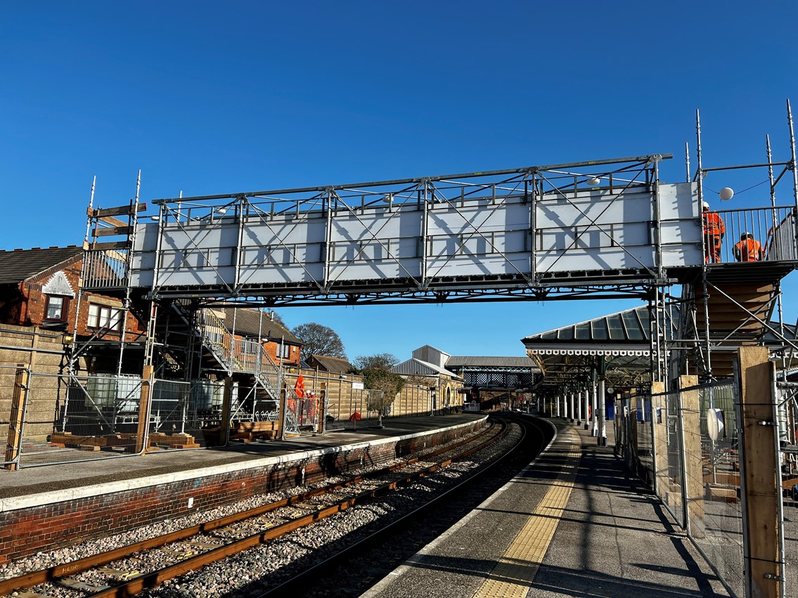 Bridlington station's temporary footbridge with the existing bridge in background - photo taken during construction on 31 January 2023