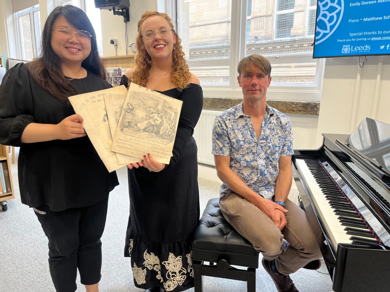 Victorian sheet music recitals: L-R singers Enson Lee, Emily Doreen Atkinson and pianist Matthew Schofield with some of the Victorian sheet music they performed at Leeds Central Library.