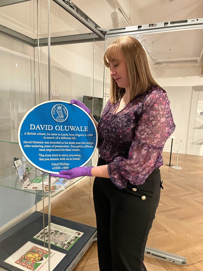 Overlooked: Preservative Party member Lauren Theweneti with the replica of David Oluwale's blue plaque, on display in Overlooked at Leeds City Museum.