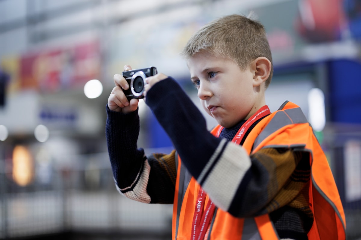 Austin taking a photo of an LNER train at Leeds station, LNER