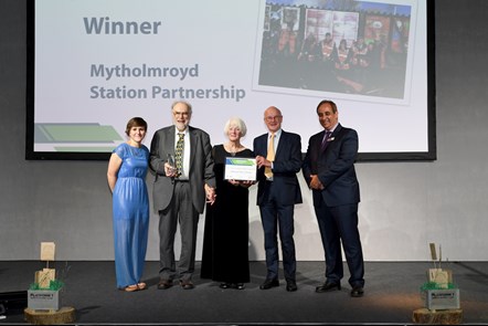 Geoff and Sue Mitchell, from Mytholmroyd Station Partnership, receiving an award for Outstanding Contribution to Community Rail in 2019