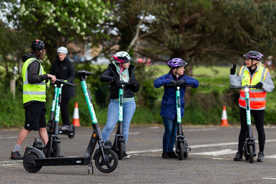 A group of riders taking part in e-scooter training with a licensed instructor in Bournemouth.