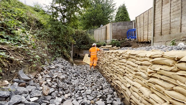 The sandbag concrete wall to protect residents' gardens